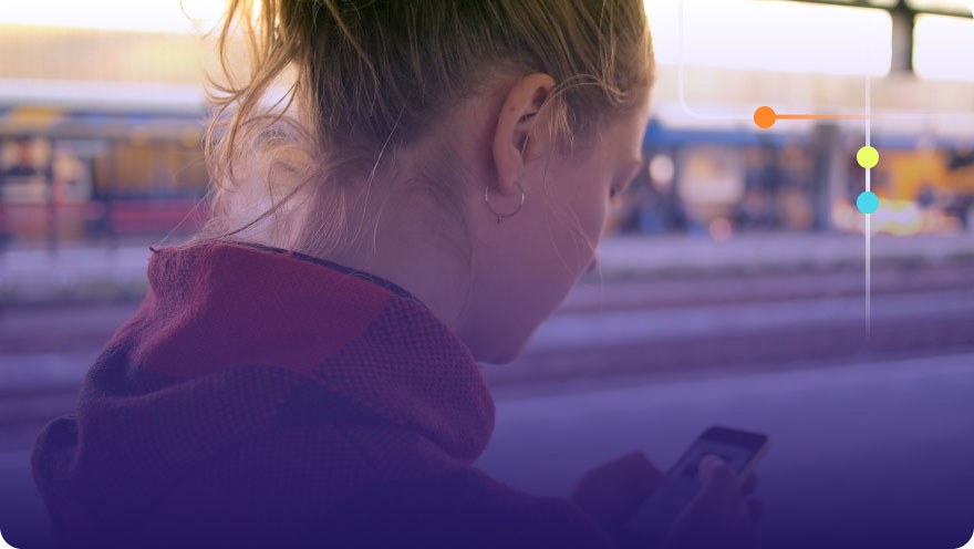 Person holding and looking down at phone